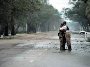 Photo of pararescueman Staff Sgt. Lopaka Mounts receiving a hug from a resident after Hurricane Ike, Sept. 13, 2008.